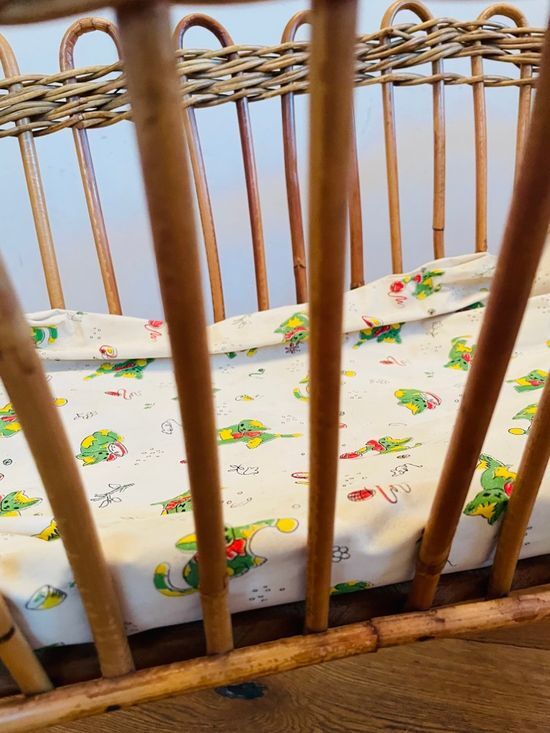 Vintage rattan doll cradle