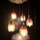 Suspension with tulips and a red scalloped lampshade.
