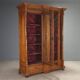 Antique walnut wardrobe with glass and carvings, Italy, 19th century.