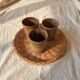 3 vintage 70s glazed stoneware cups and the wicker tray.