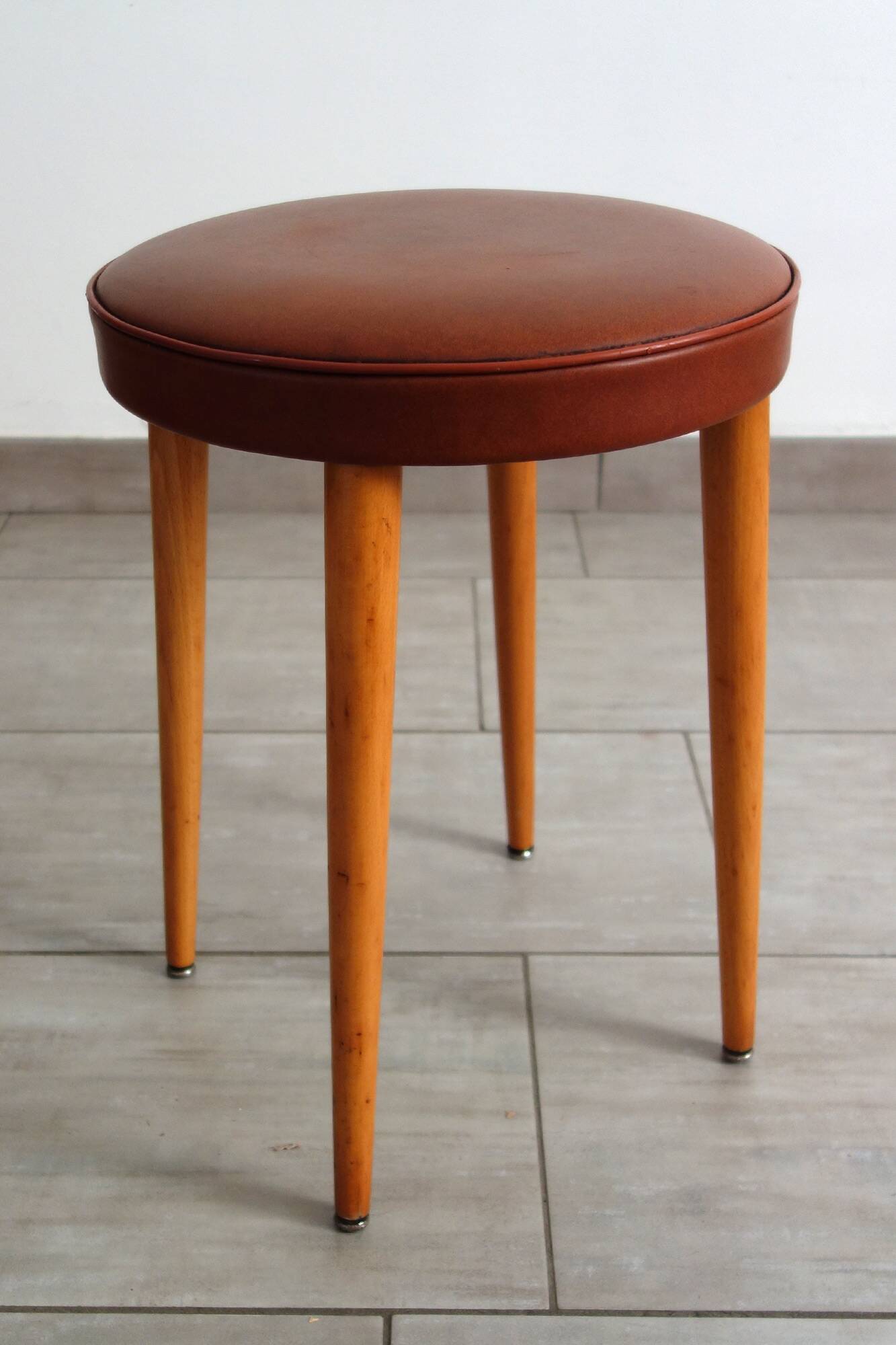 Baumann low stool from the 60s in brown leatherette