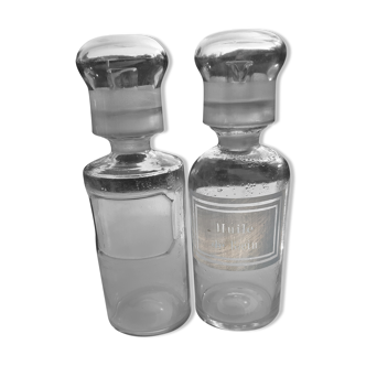 Pair of transparent glass pharmacy bottles