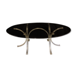 Table ovale en verre fumé pieds arcs en acier chromé
