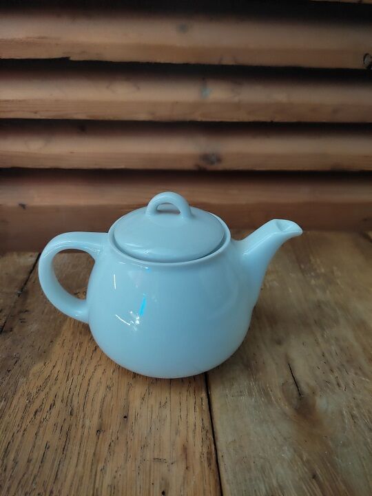 Tea pitcher teapot in old vintage white porcelain