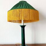 Green ceramic lamp with a vintage pleated fringe shade.