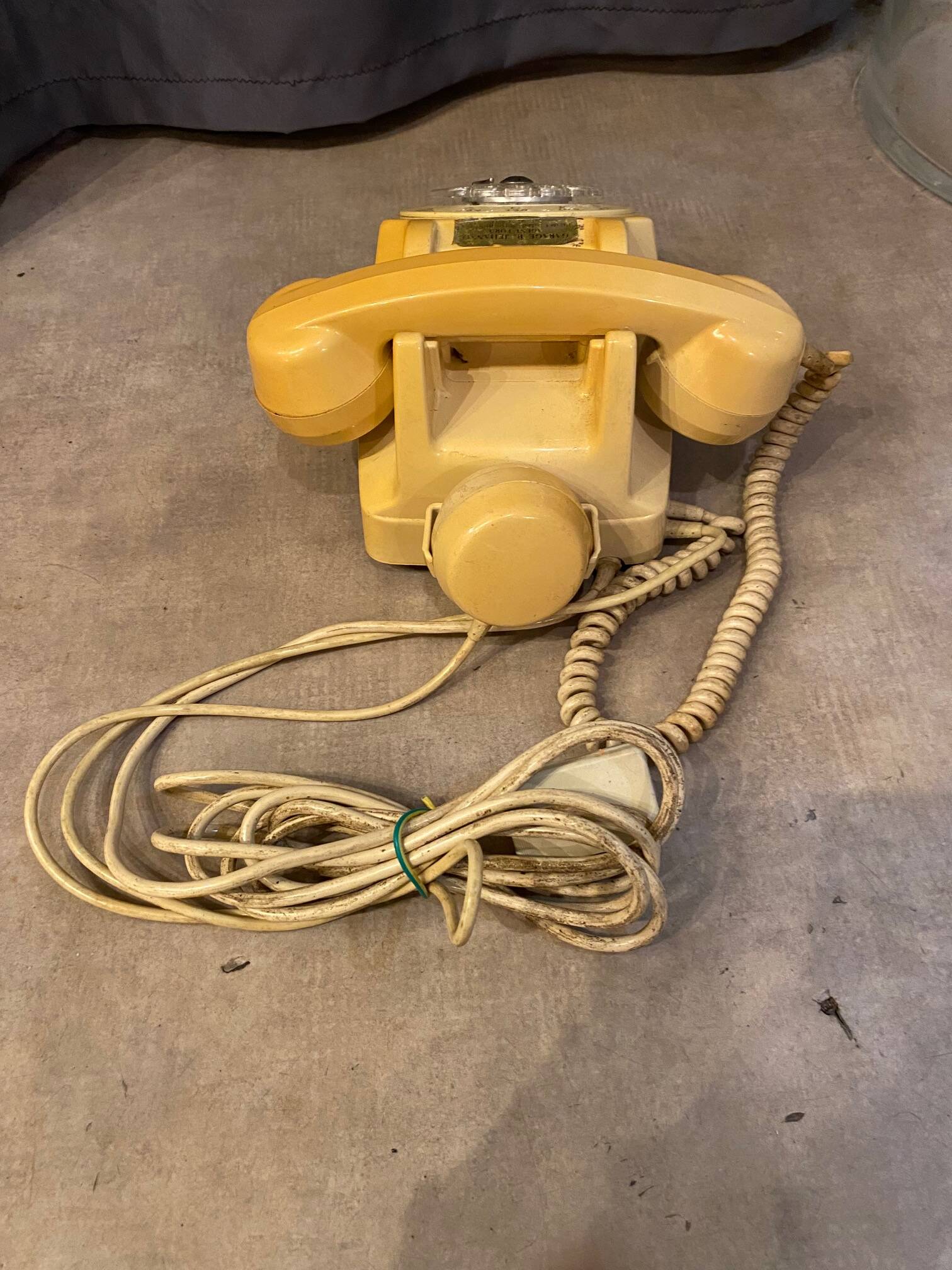Old dial telephone from the 80s temat quimper bakelite yellow and beige