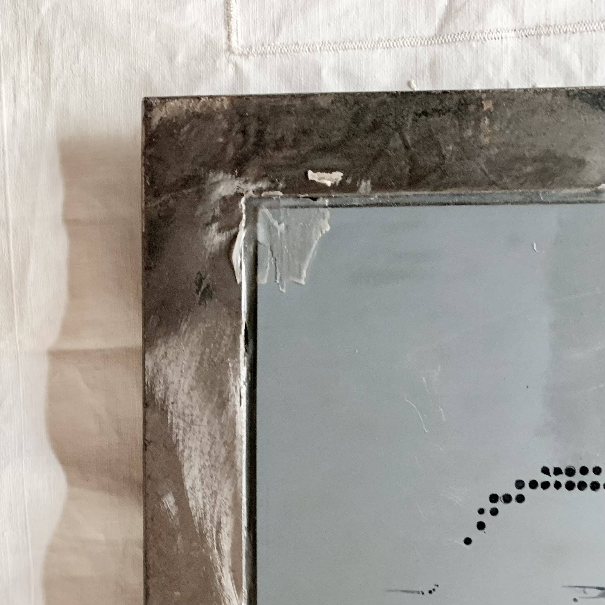 Vintage wall mirror in varnished steel decorated with a rose in relief