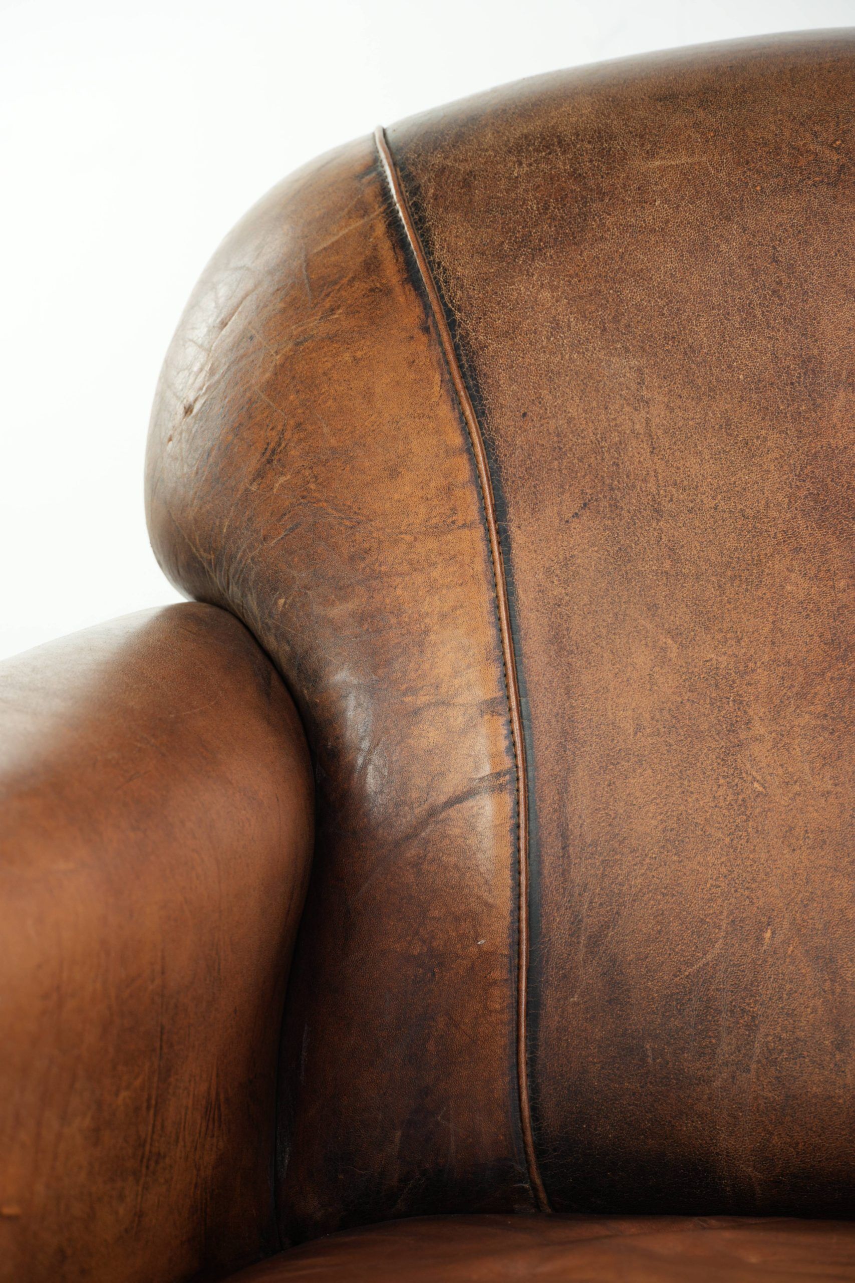Comfortable characterful sheepskin armchair finished with decorative nails
