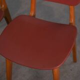 Set of 4 designer chairs in oak and red leatherette from the 1960s