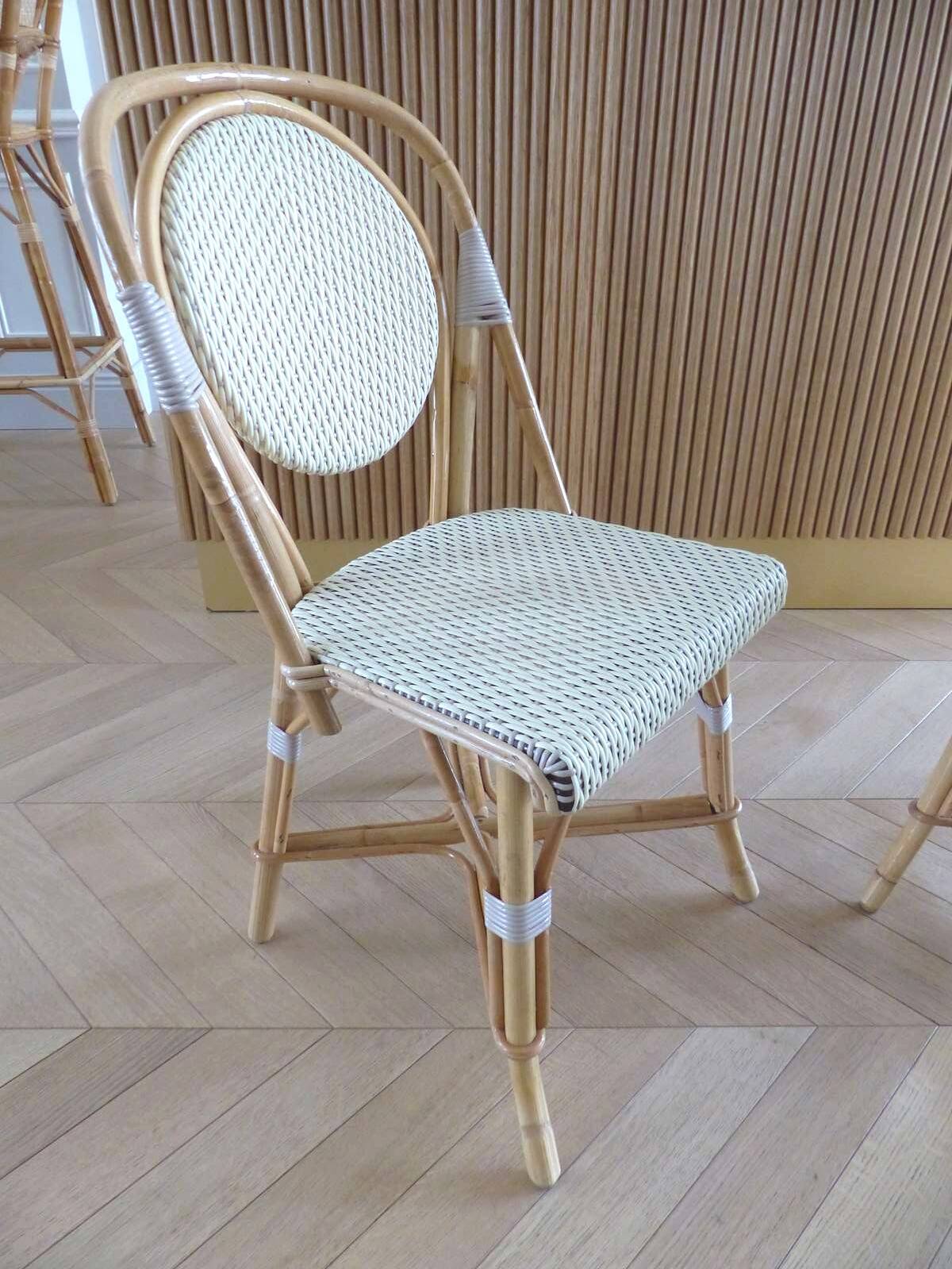 Pair of Parisian bistro chairs from Maison Louis Drucker in light Manila rattan.