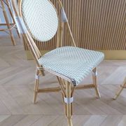Pair of Parisian bistro chairs from Maison Louis Drucker in light Manila rattan.