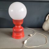 Vintage globe lamp with a metal base, perforated and lacquered in red.