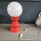 Vintage globe lamp with a metal base, perforated and lacquered in red.