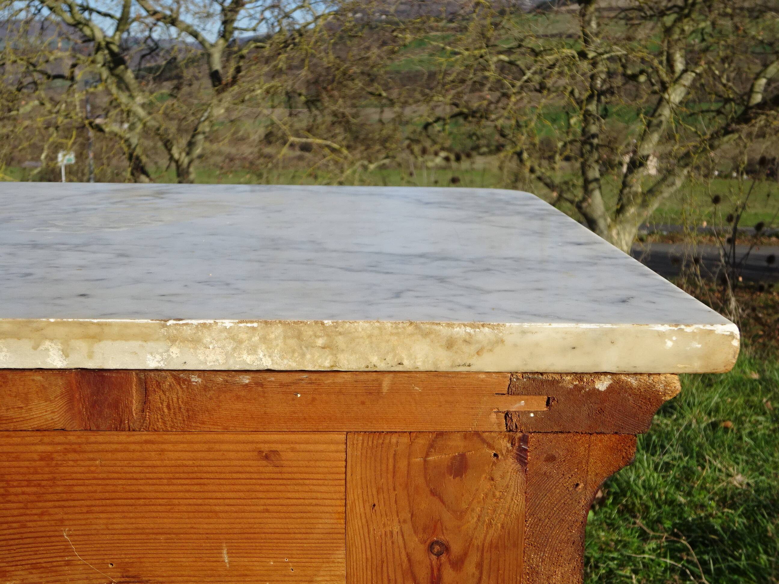 Antique mahogany chest of drawers with white marble.