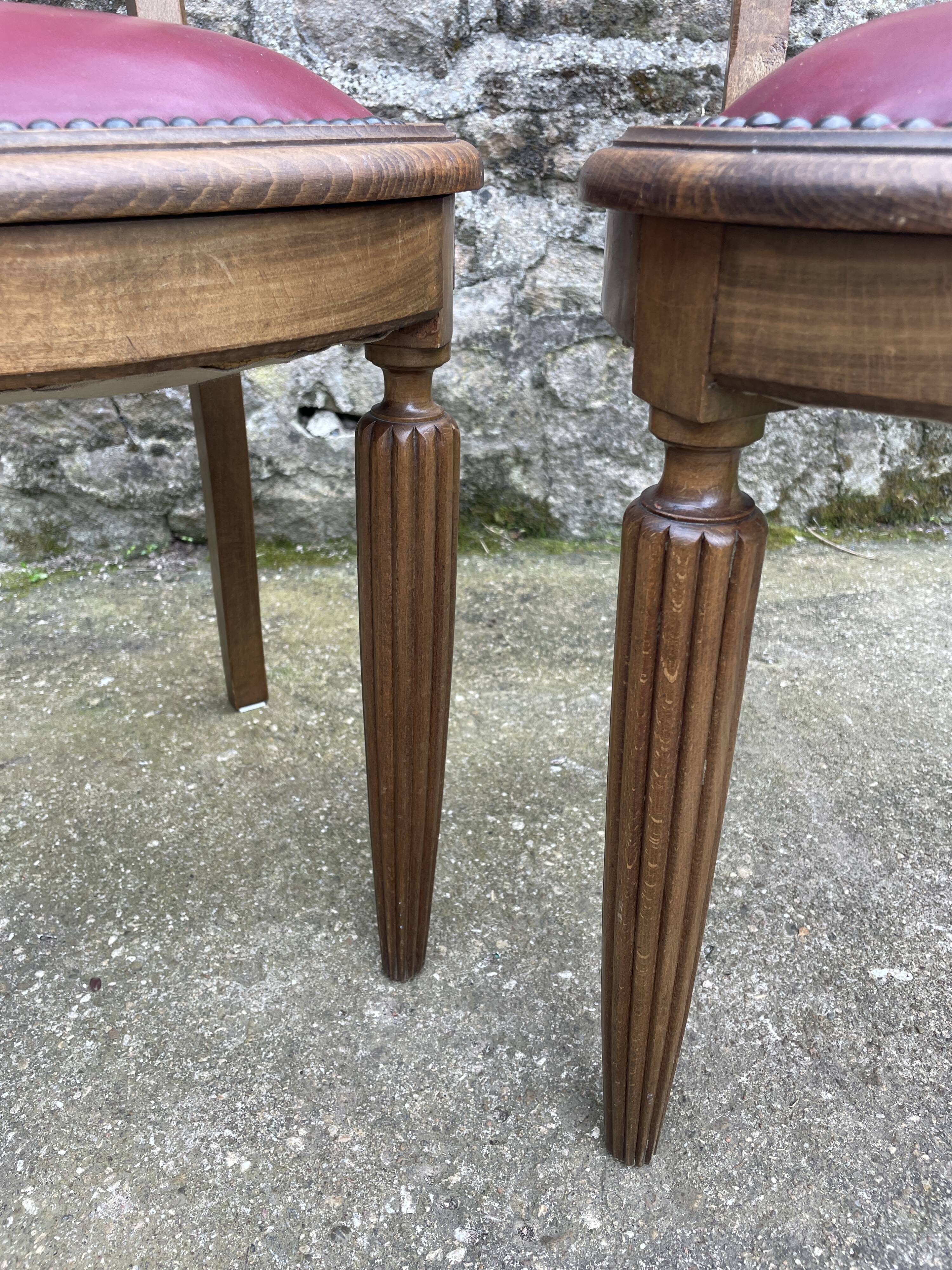 Pair of studded burgundy leather Art Deco chairs