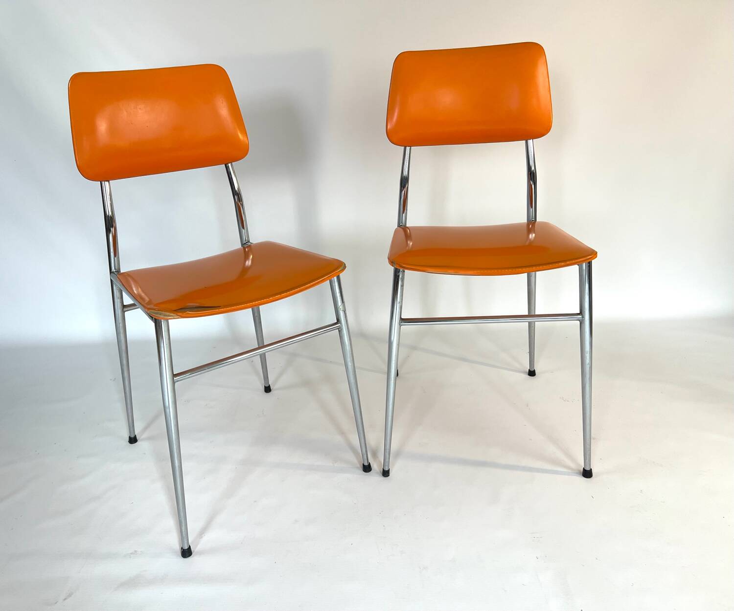 Pair of vintage orange leatherette chairs