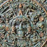 Aztec/Mayan wall solar mirror, in crushed Malachite stone, gold highlights