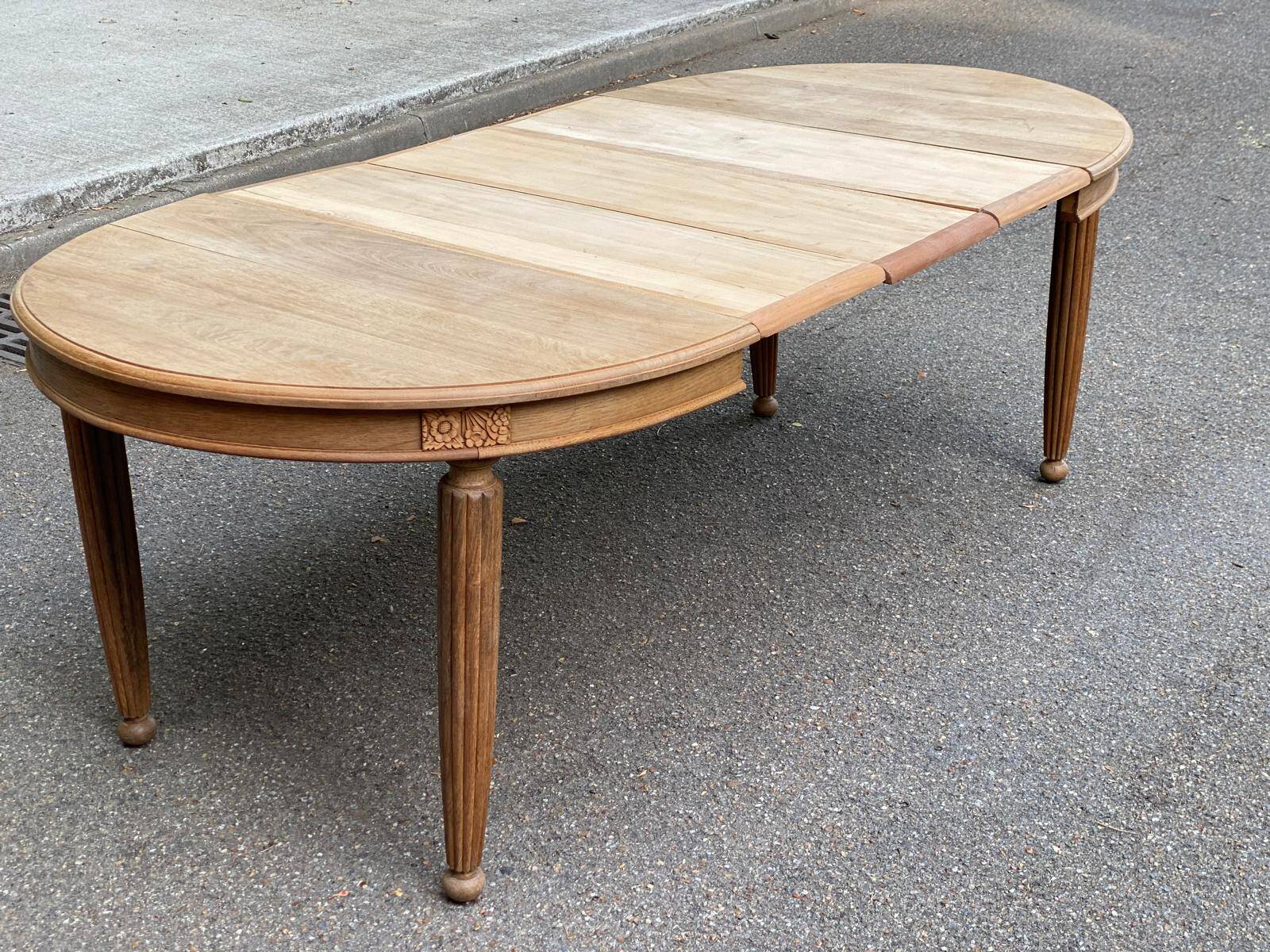 Large stripped solid oak dining table in Louis XVI style with 3 extensions.