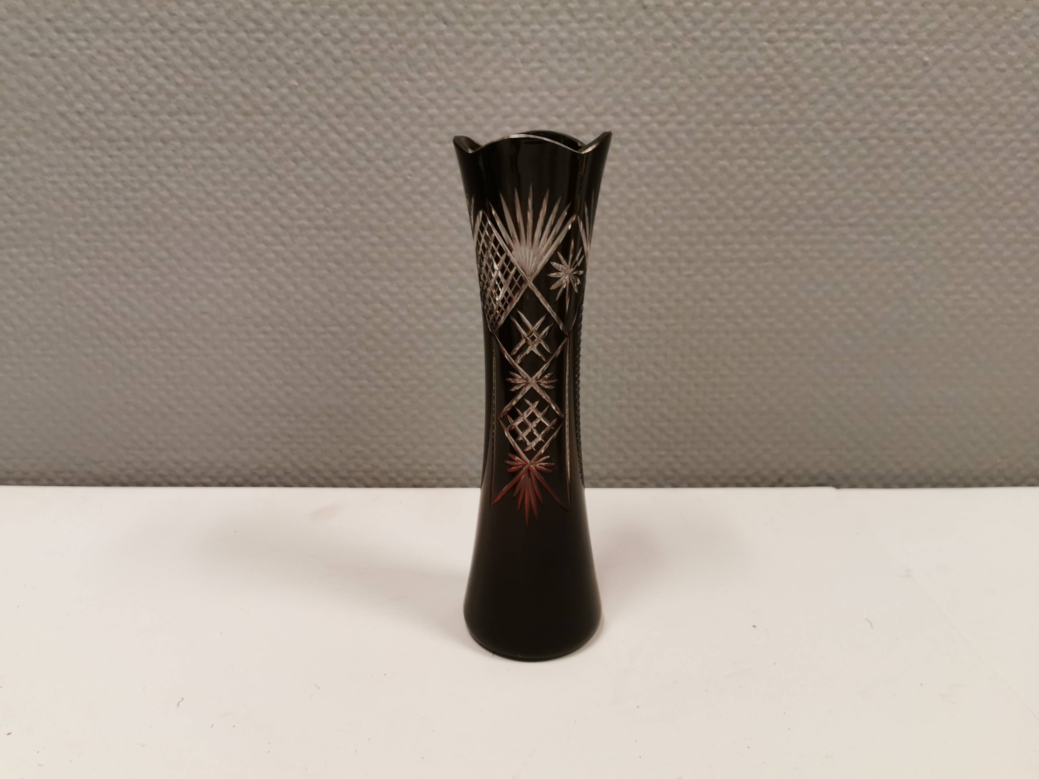 Crystal glass vase, in burgundy/reddish coloured glass with translucent details.