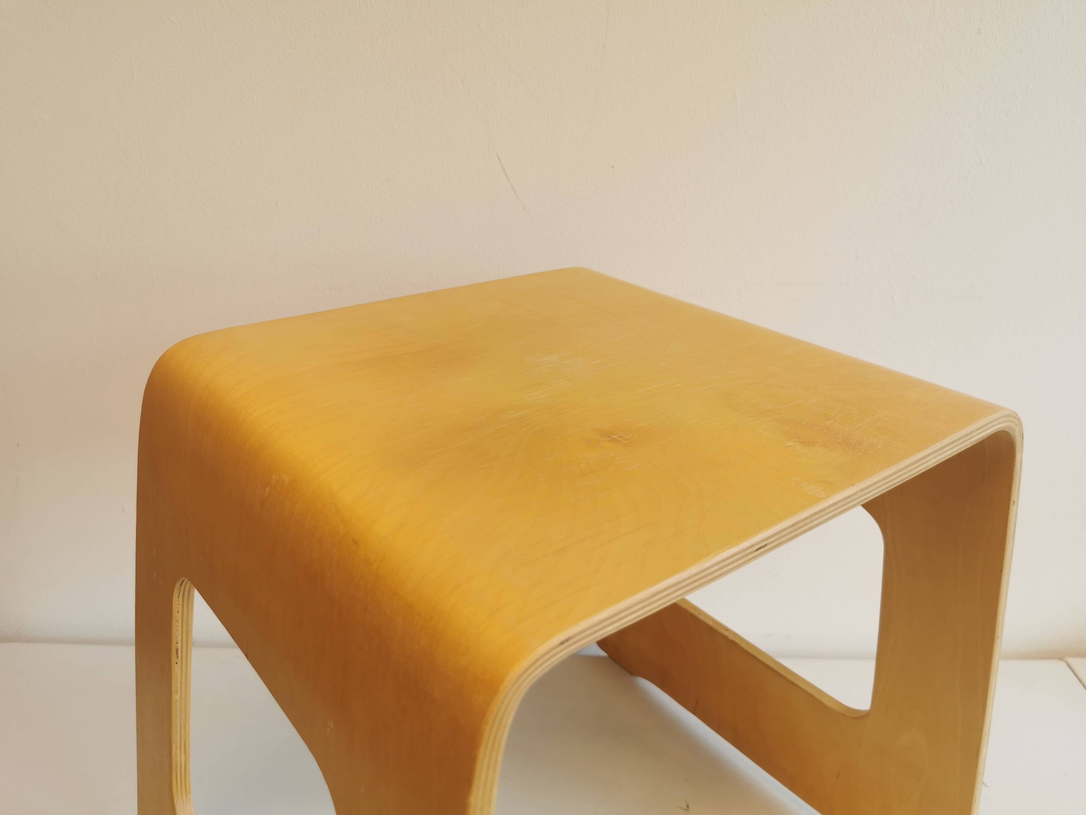 Design stool/side table made of curved plywood.