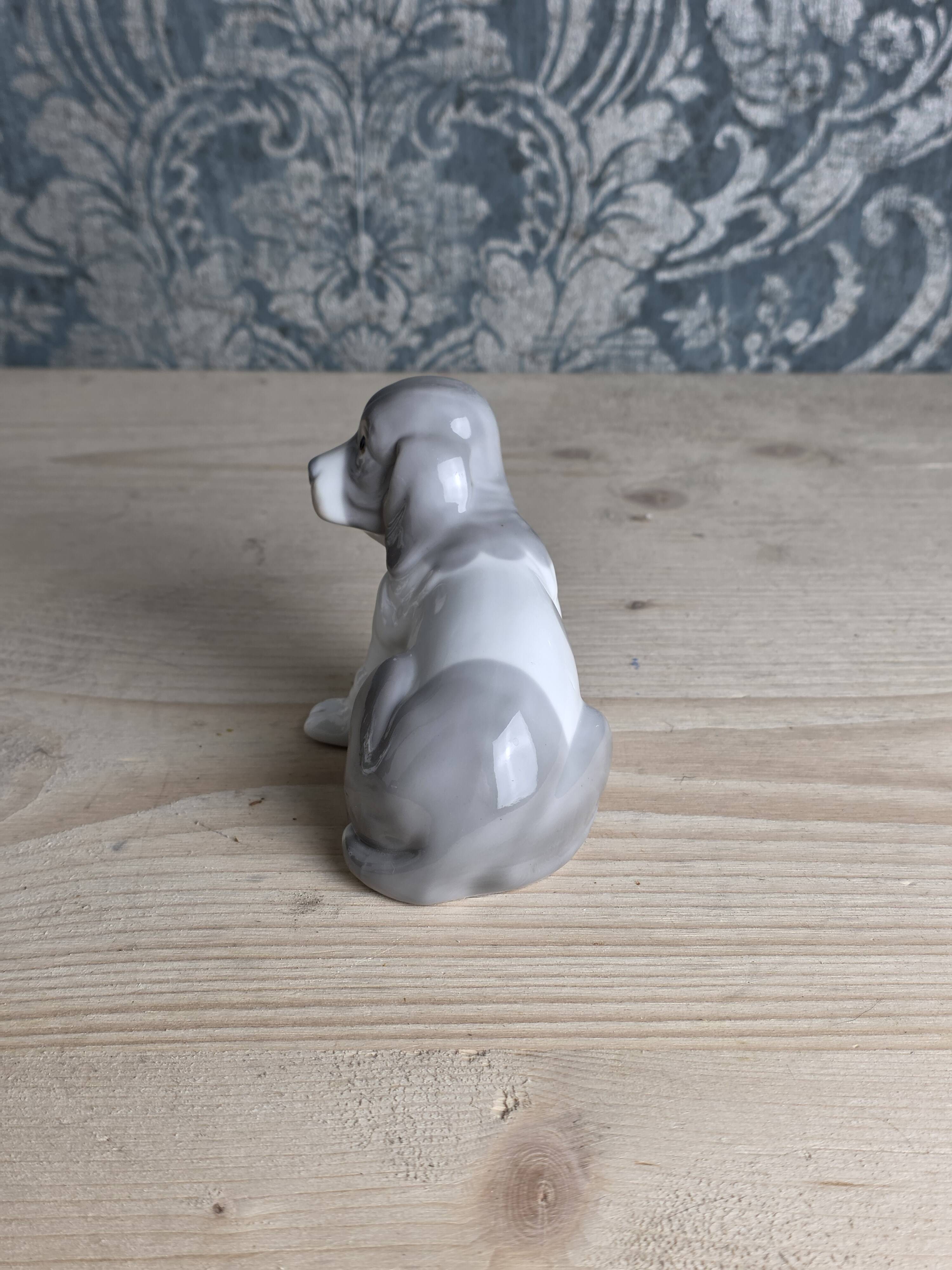 Small spaniel dog in porcelain