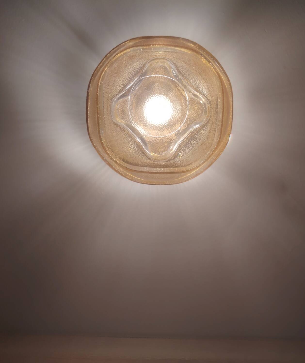 Textured amber globe wall light