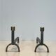 Pair of modernist fire dogs in wrought iron and brass