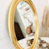 Oval wall mirror in gilded wood