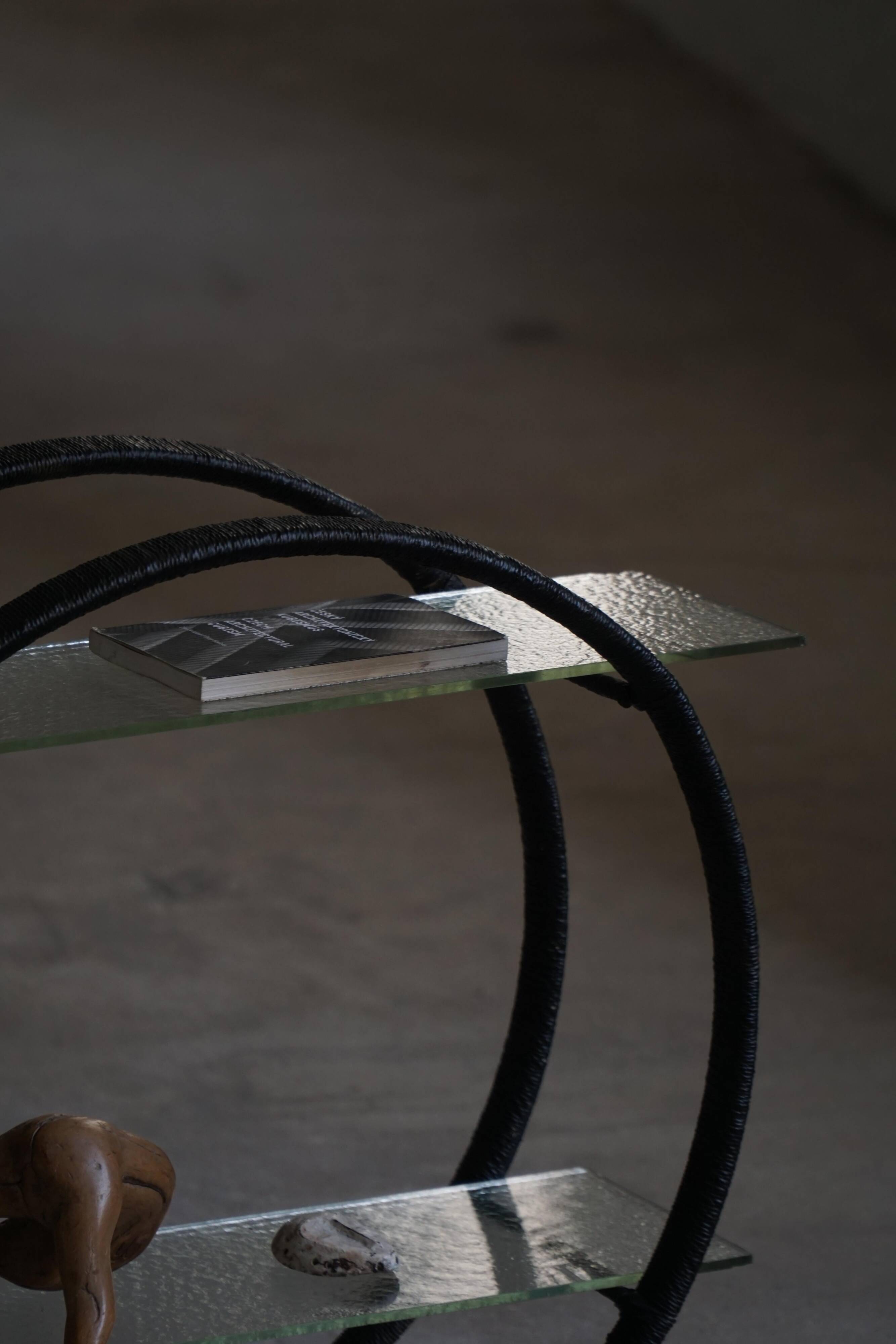 Decorative shelf unit, round metal frames with curved legs and glass shelves, 1960.