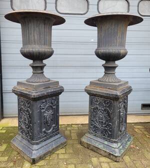 Large antique cast iron vases on pedestal