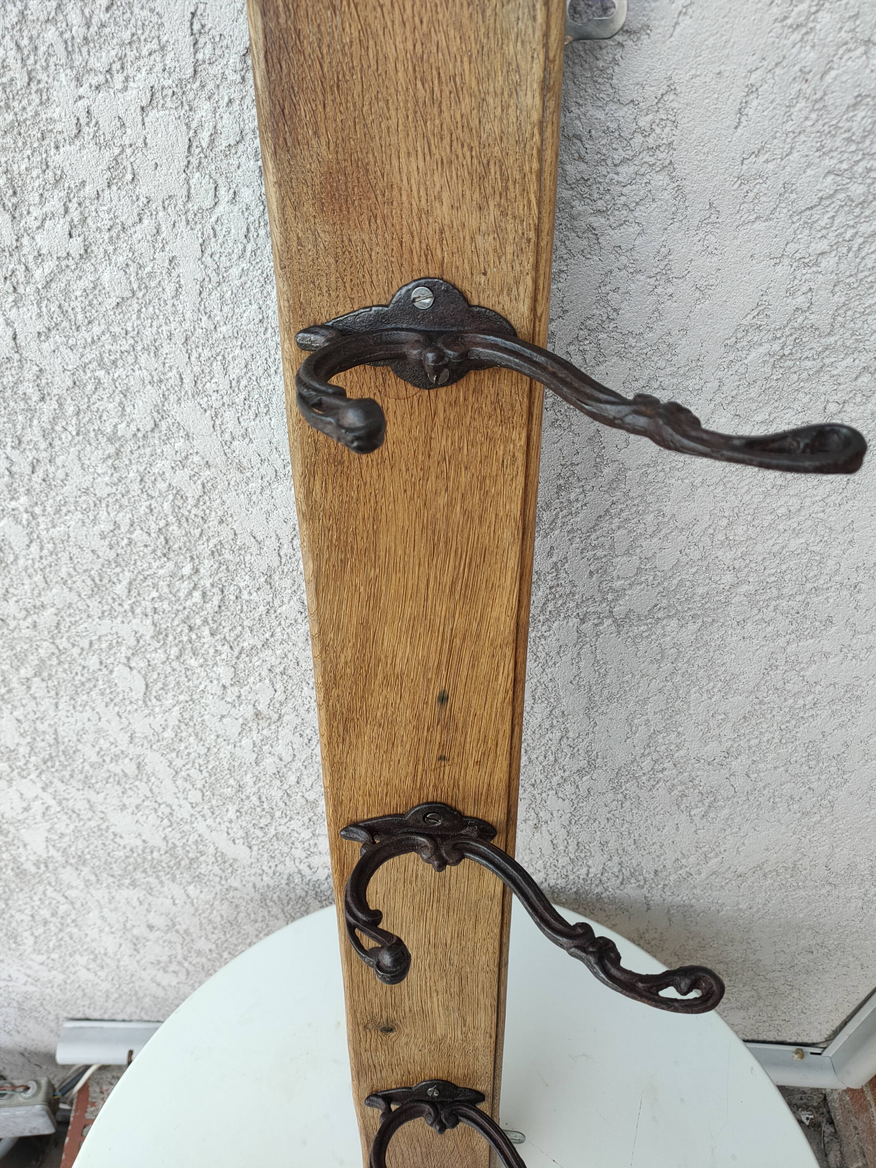 antique coat rack with 3 cast iron hooks