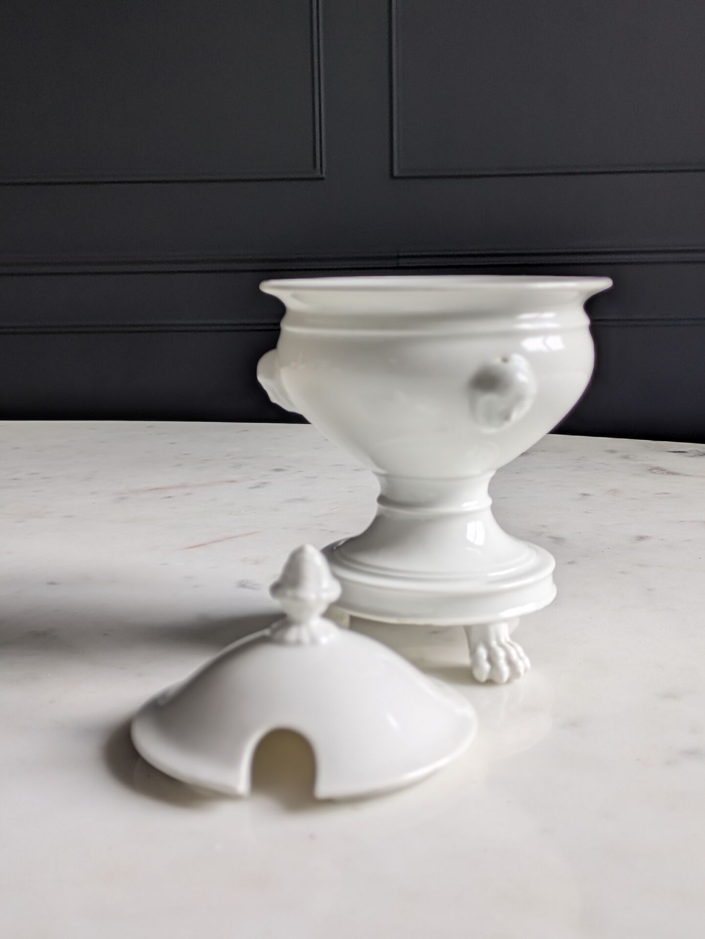 White porcelain confiturier with lion paws and masks. 19th century.