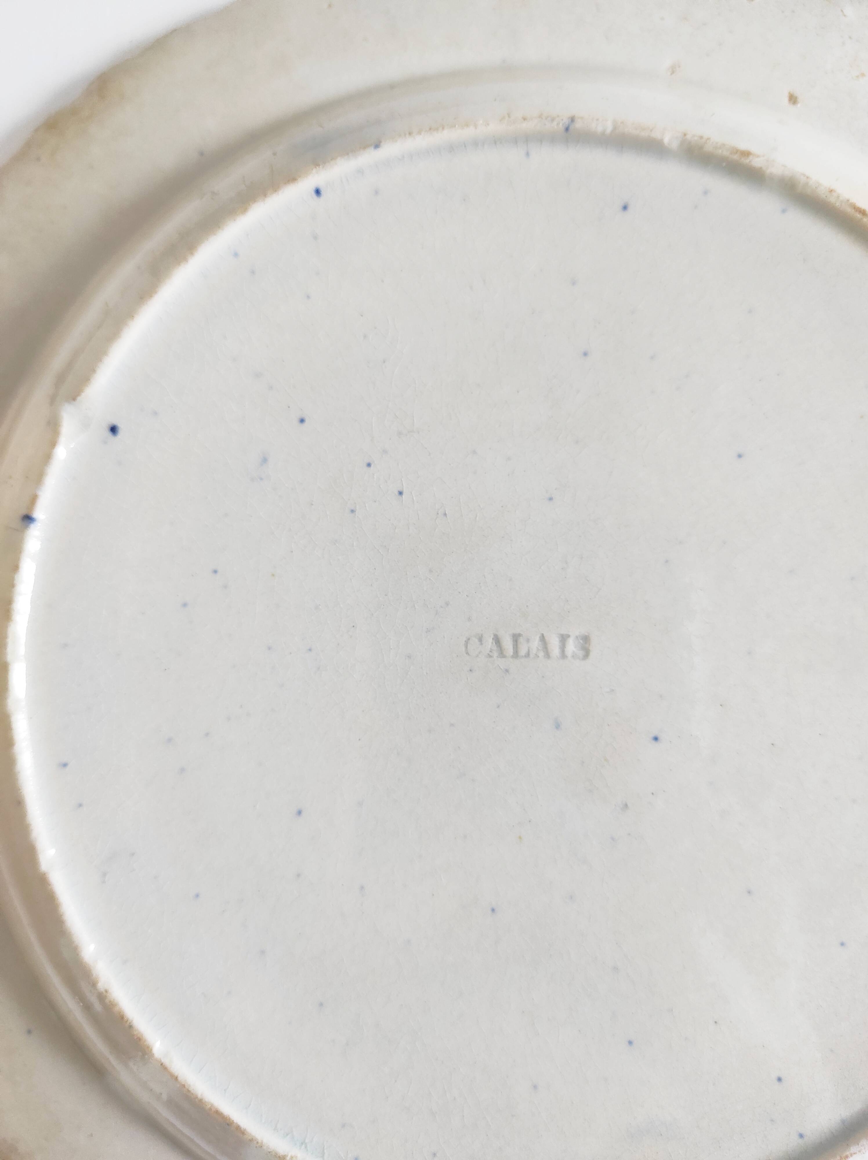 Five 19th century Calais earthenware plates with a romantic gallant couple decor