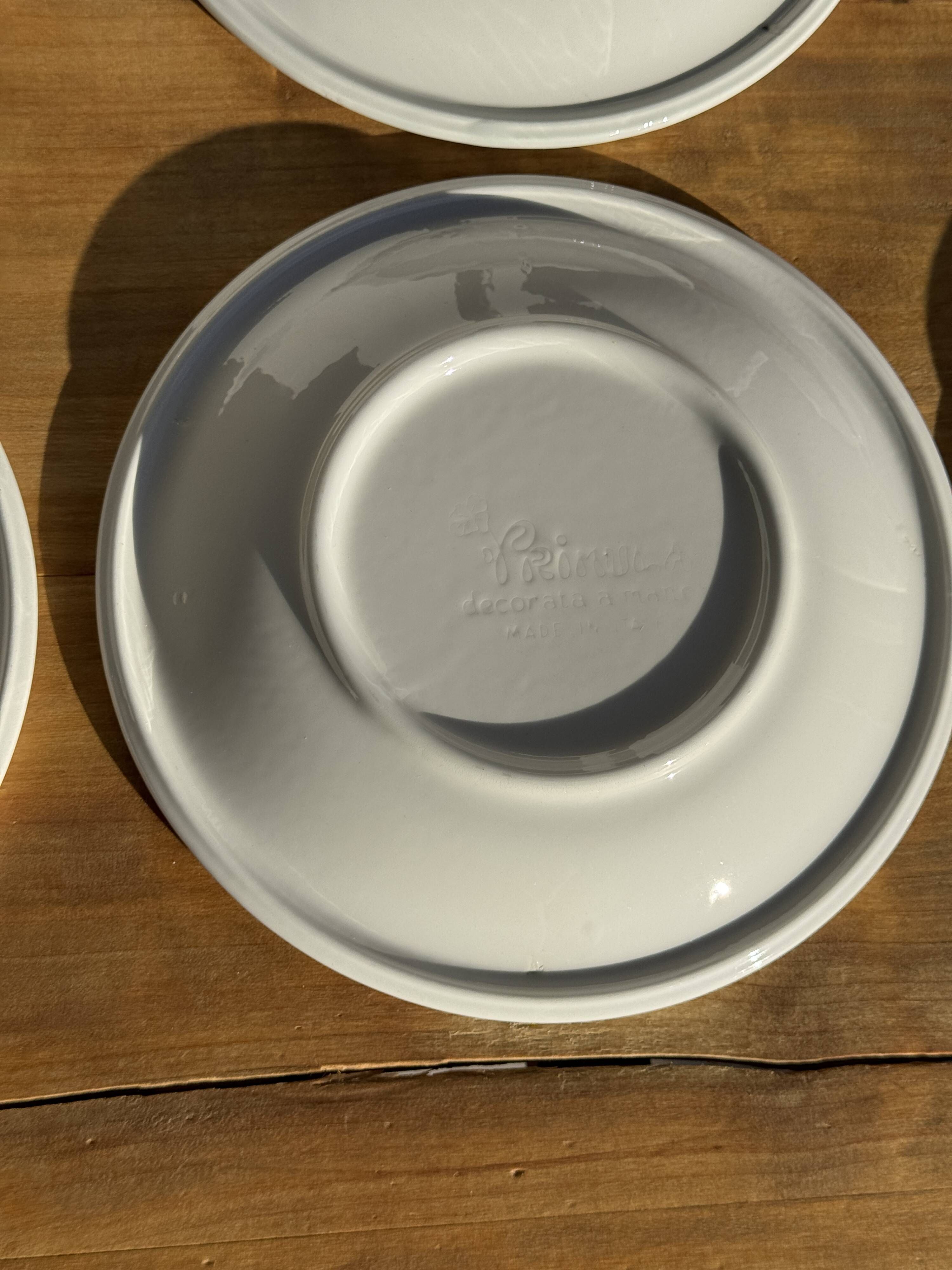 Set of 9 small Italian dessert plates Primula with red and green trim.
