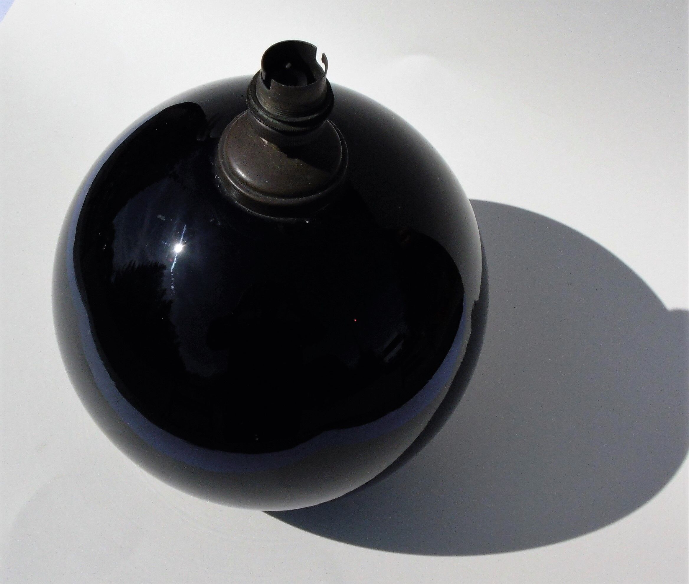 Old lamp foot shaped ball in black glass