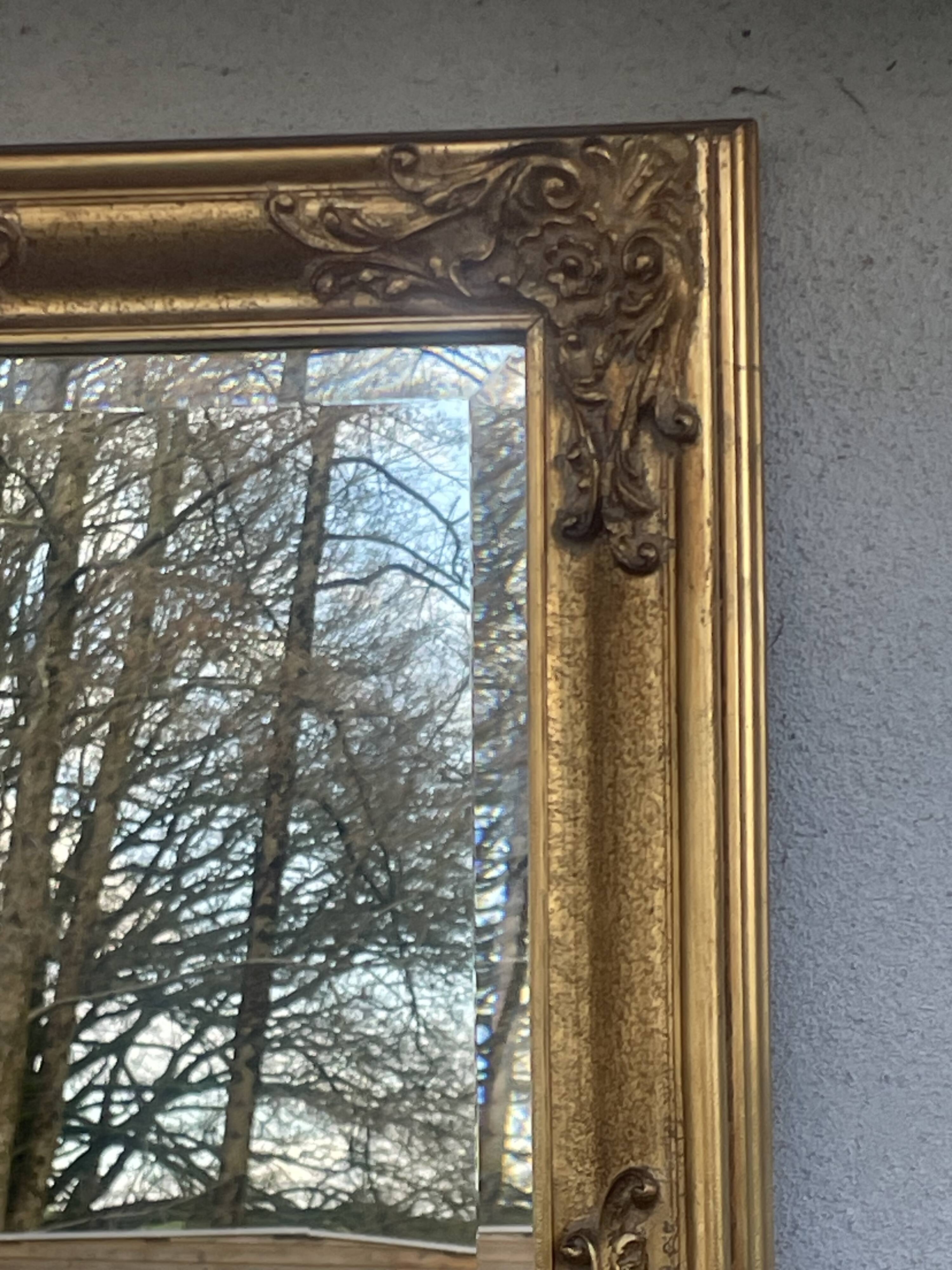 vintage bevelled mirror in rectangular shape, stucco and gilded wood in Louis XV baroque style