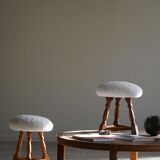 Modern Danish, a pair of tripod stools, seats reupholstered in lambswool, 1950s.