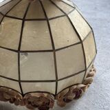 Vintage pendant light with a pearlescent shade and floral decoration.