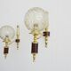 Golden wall lamps with round glass shades and teak veneer