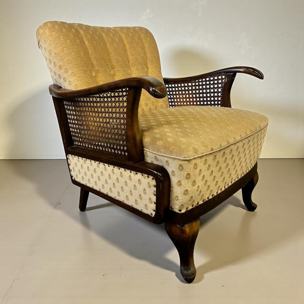 Vintage wooden armchair with rattan weaving.