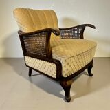 Vintage wooden armchair with rattan weaving.