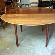 Elegant round teak table with extension.