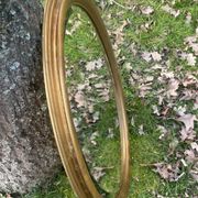 Bevelled golden oval mirror, 79 x 59 cm
