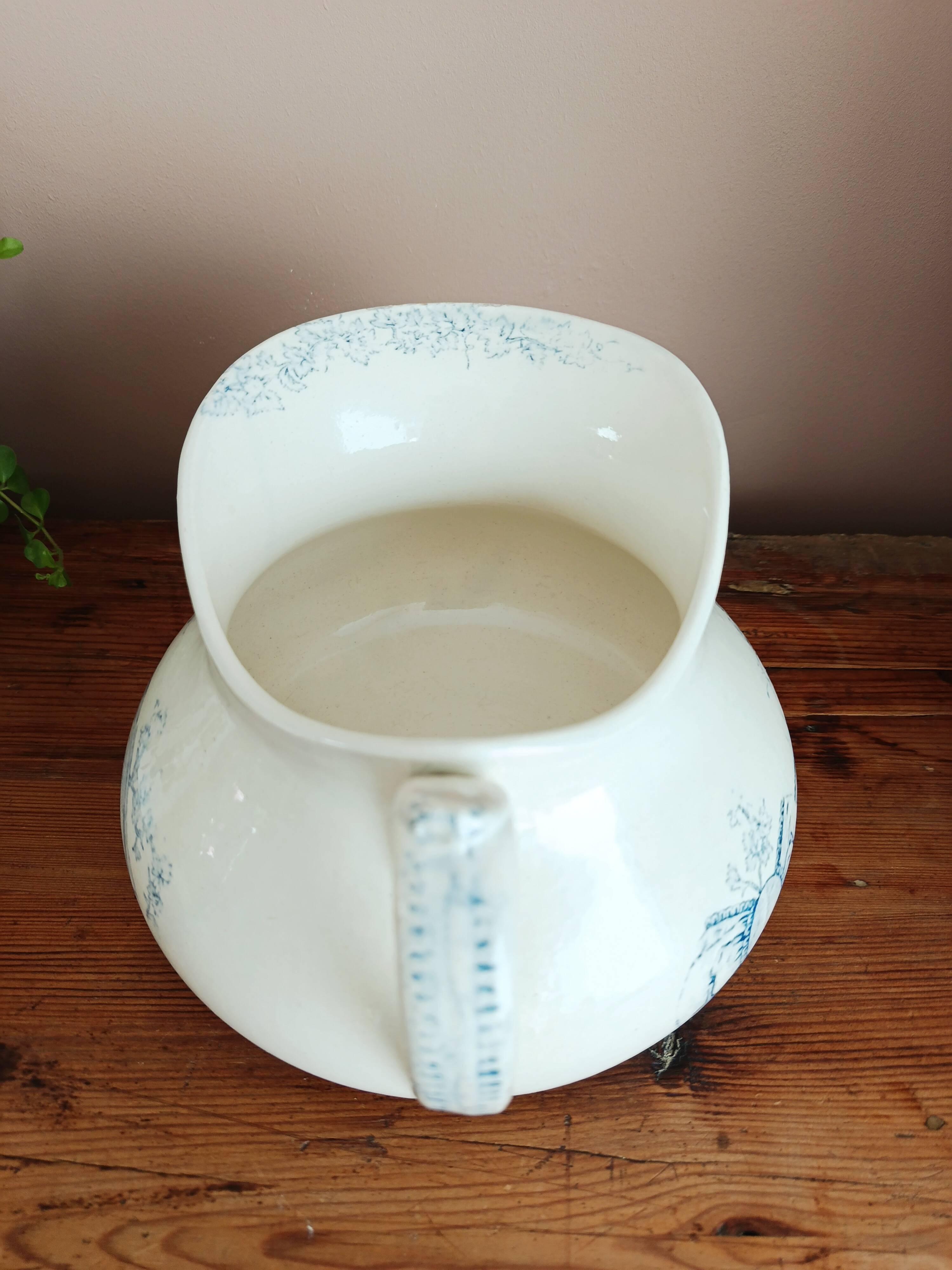 Old bulbous jug in ironstone earthenware