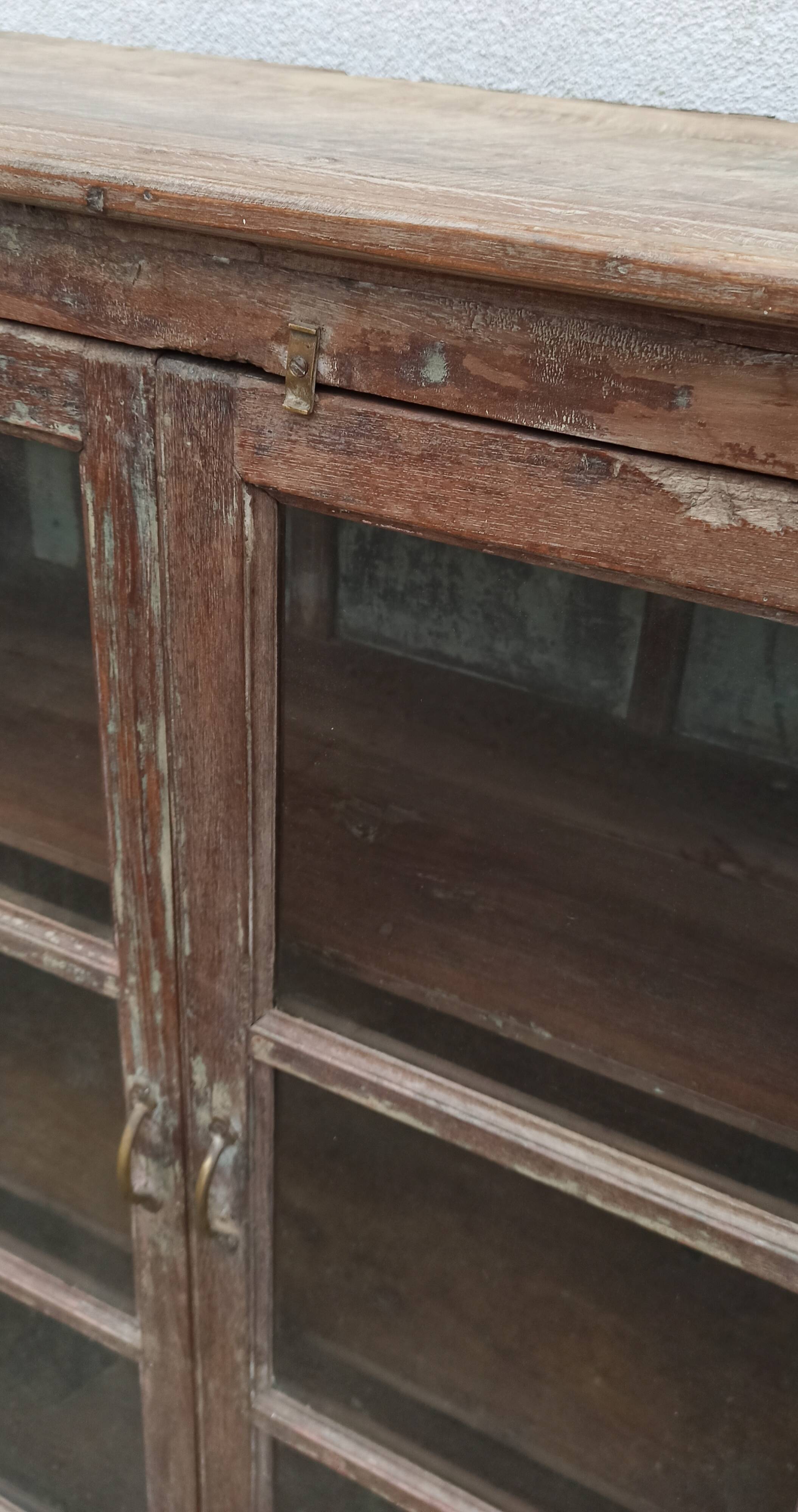 Old glazed wooden cabinet with metal bottom