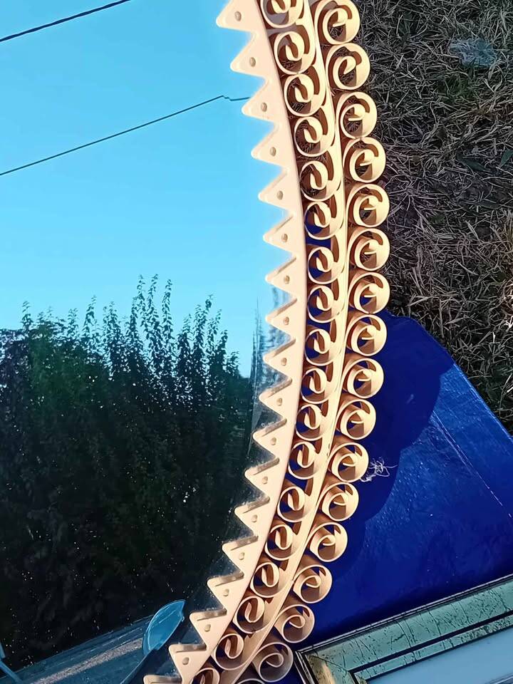 Engraved mirror surrounded by metal