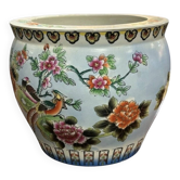 Antique porcelain vase with floral and bird decoration.