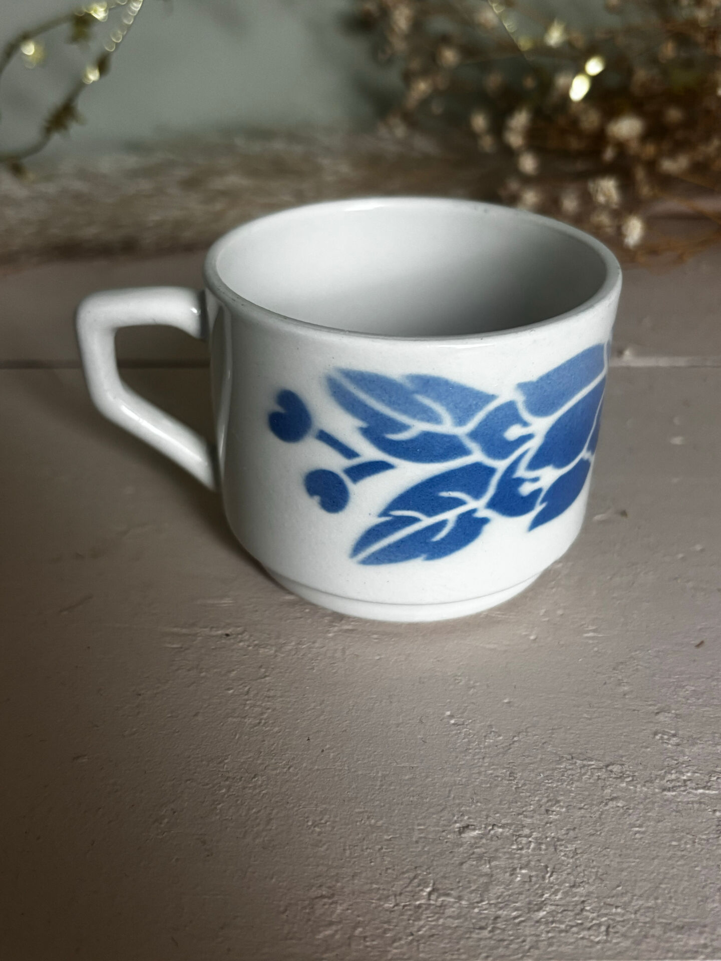 Set of 3 antique ceramic cups with blue floral pattern.