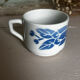 Set of 3 antique ceramic cups with blue floral pattern.