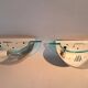 Pair of gold metal and plexiglass wall lights, circa 1980.